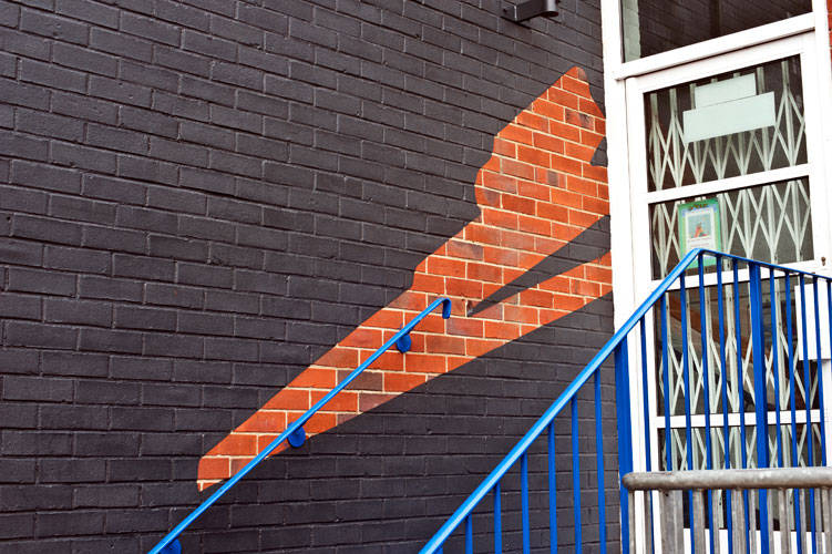 exposed brick suggests a track or path